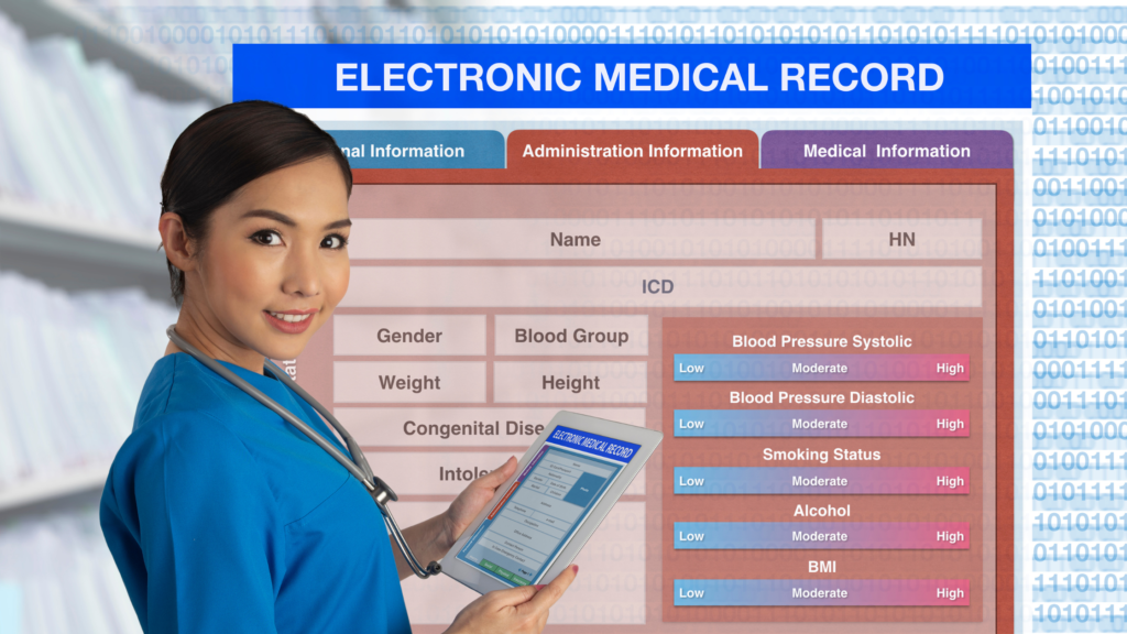 A nurse holds a tablet in front of a screen that shows an electronic medical record.